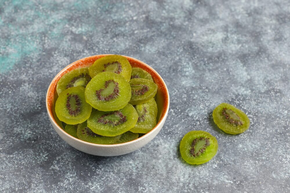 Dried homemade kiwi fruit with fresh kiwi.