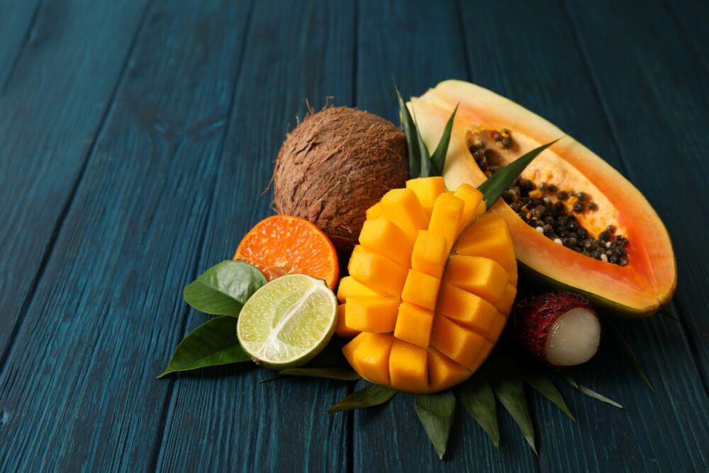 Fresh ripe exotic fruits on wooden background