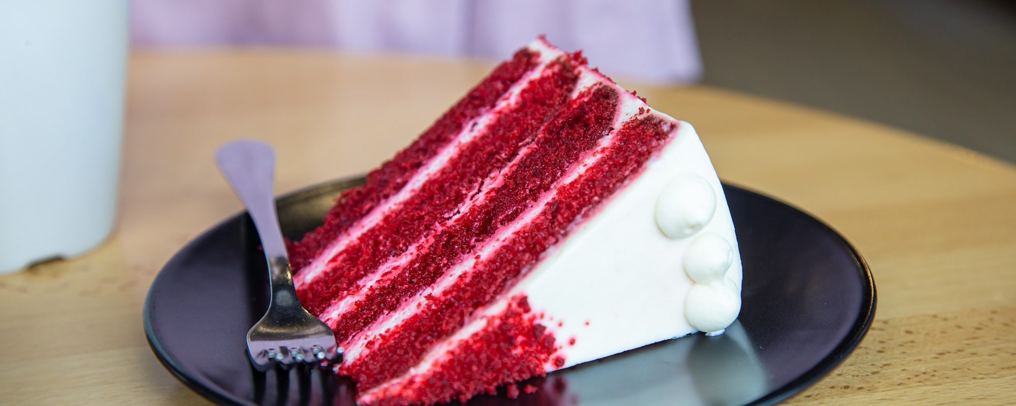 Close-up of a piece of red velvet cake on a plate.